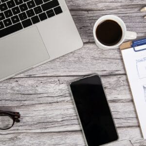 Website designer work table with laptop and a smart phone on a wooden desk